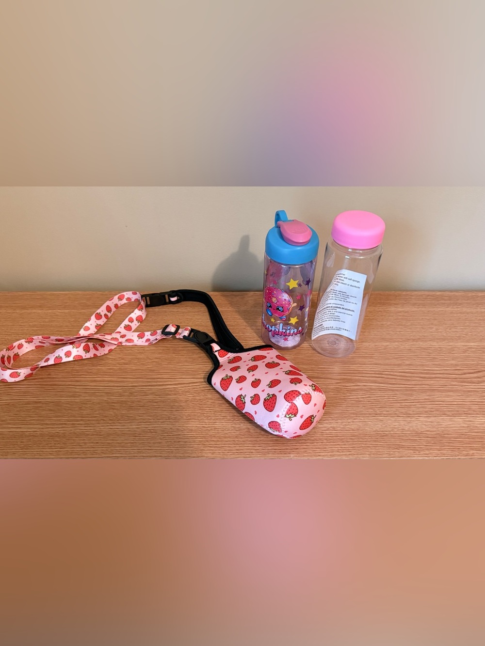 The kids’ Strawberry Print Water Bottle Carrier included two water bottles.